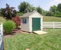 Beige Cape Cod Style Gable Shed with Green Doors